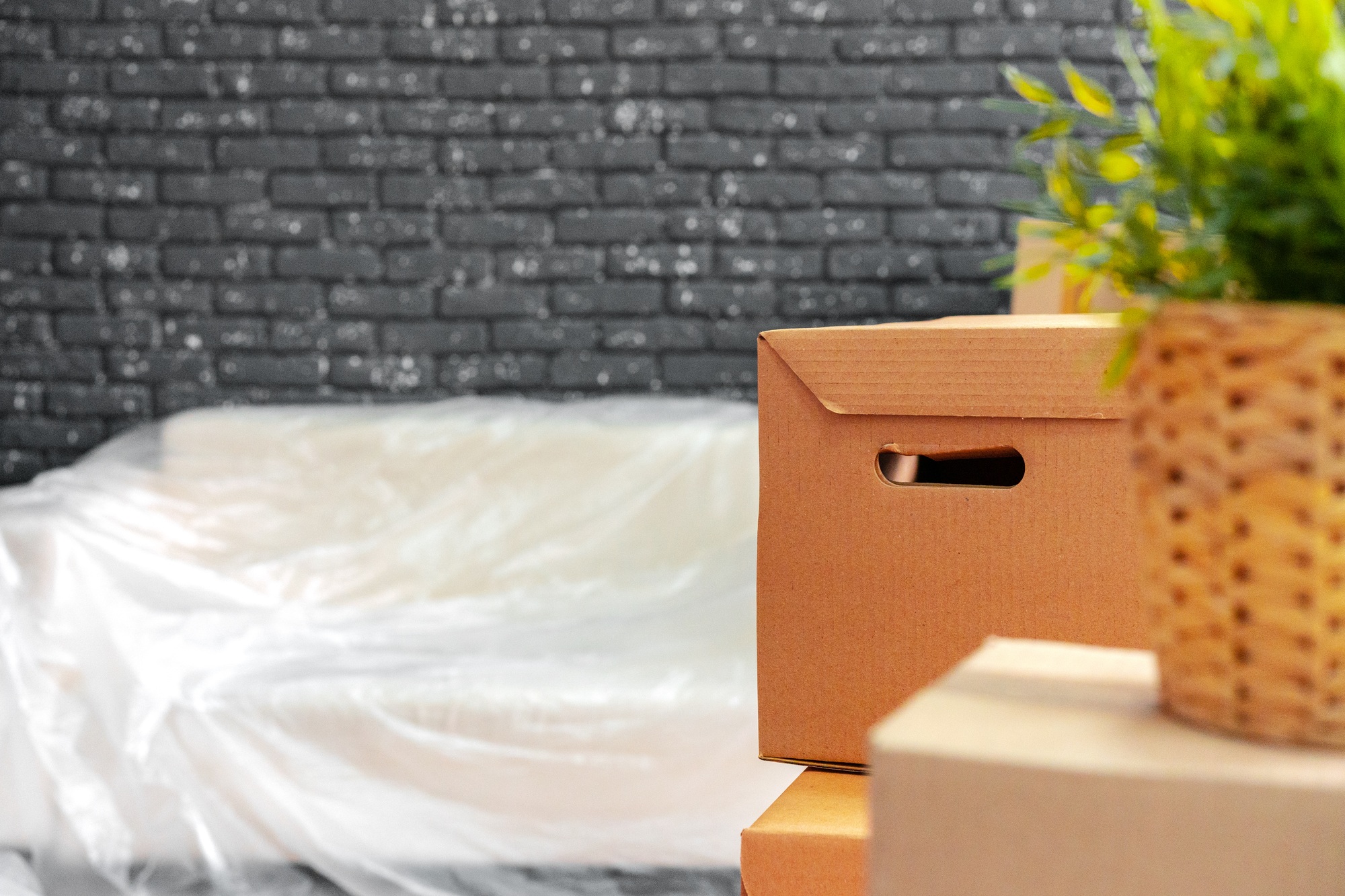 Moving in or moving out concept. Stack of boxes and packed furniture